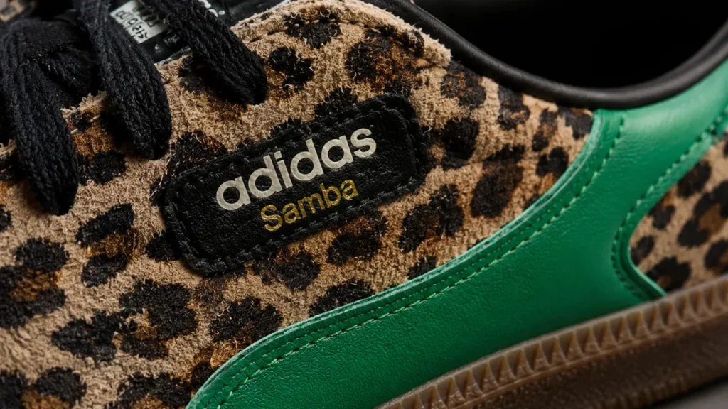 Close-up of leopard-print adidas Samba with green accent panel showing suede texture and detailed stitching